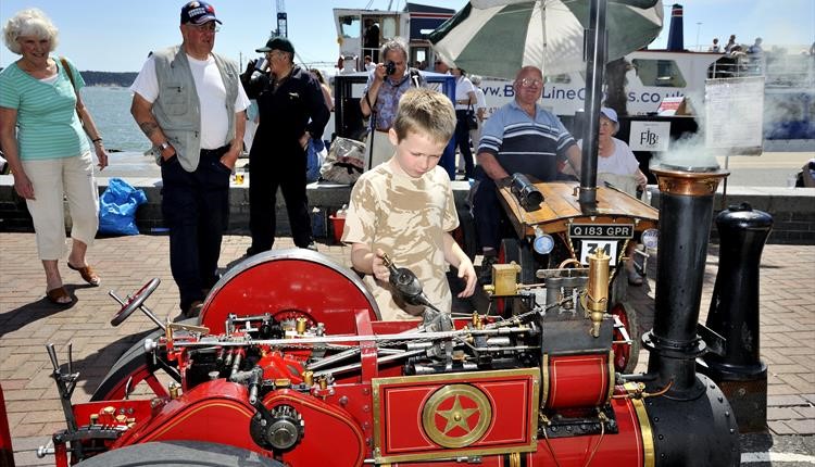 Child interacting with a Steam engine on Poole Quay